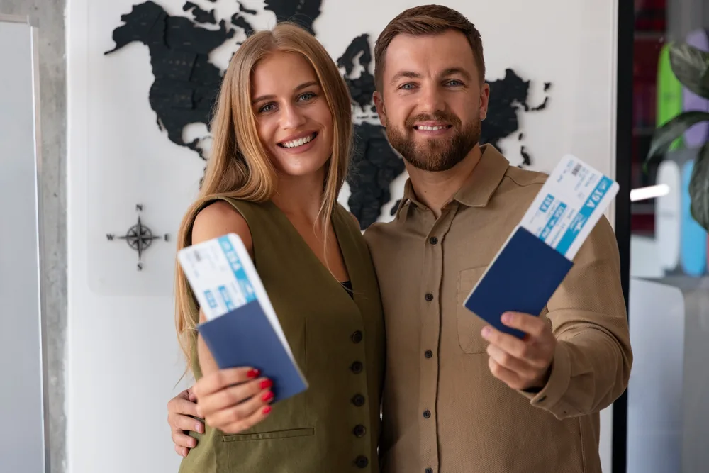 Couple holding passports and tickets